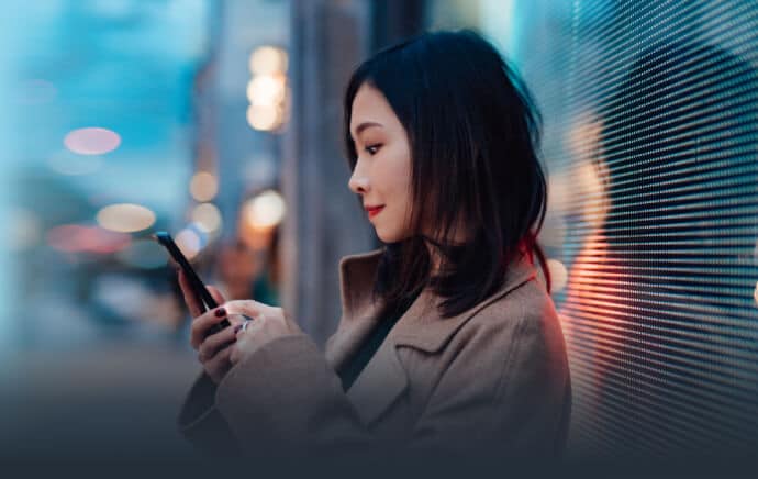 Woman on street using mobile phone